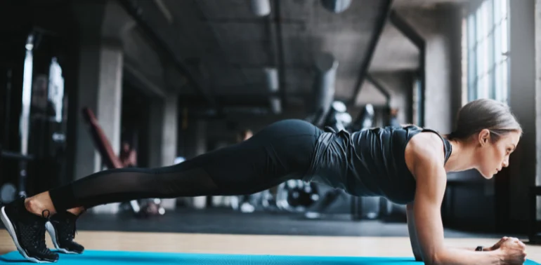 Physiotherapist providing core stability training for athletes at home in Karachi