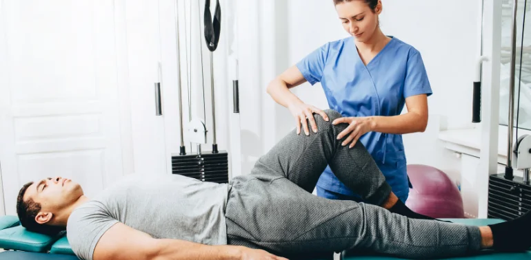 Physiotherapist providing groin strain physiotherapy treatment at home in Karachi