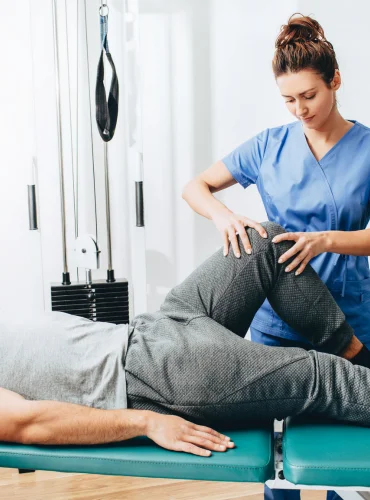 Physiotherapist providing groin strain physiotherapy treatment at home in Karachi