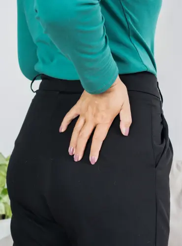 Physiotherapist providing hip impingement physiotherapy treatment at home in Karachi