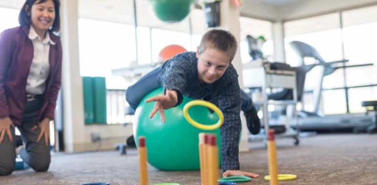 Physiotherapist providing pediatric muscle weakness physiotherapy treatment at home in Karachi