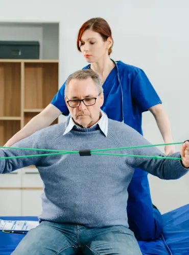 Physiotherapist providing physiotherapy treatment for postural instability in elderly patients at home in Karachi