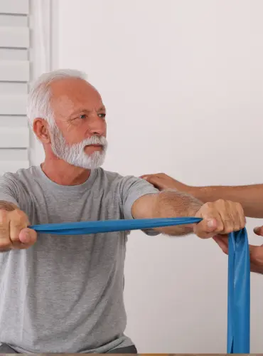 Physiotherapist providing sarcopenia physiotherapy treatment at home in Karachi