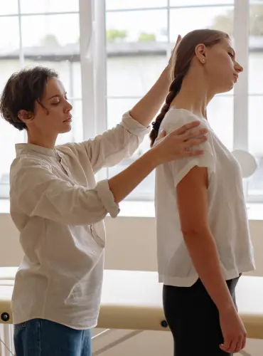 Physiotherapist providing torticollis physiotherapy treatment at home in Karachi